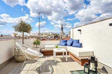 This is an example of a mediterranean rooftop deck in Madrid with an outdoor shower.