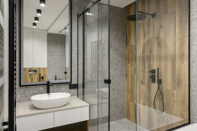 Bathroom - mid-sized modern gray tile and ceramic tile gray floor and single-sink bathroom idea in New York with flat-panel cabinets, a one-piece toilet, white walls, soapstone countertops and a floating vanity