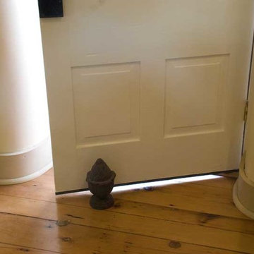 Window turned door features curved plaster walls extended to the floor.