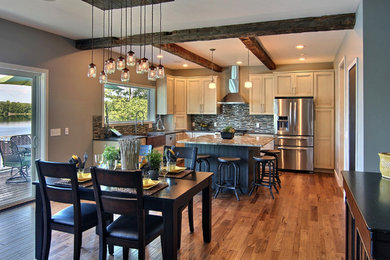 Eat-in kitchen - large farmhouse l-shaped dark wood floor and brown floor eat-in kitchen idea in Grand Rapids with a farmhouse sink, recessed-panel cabinets, white cabinets, granite countertops, multicolored backsplash, matchstick tile backsplash, stainless steel appliances and an island