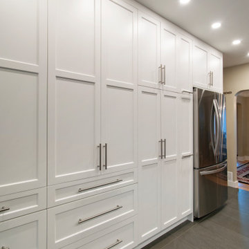 Functional & Stylish White Kitchen with Dark Countertops and Backsplash