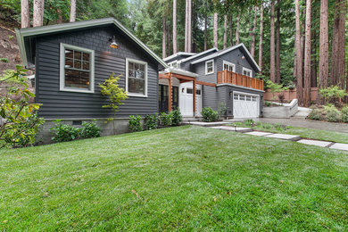 Example of a large transitional gray two-story concrete fiberboard exterior home design in San Francisco with a mixed material roof