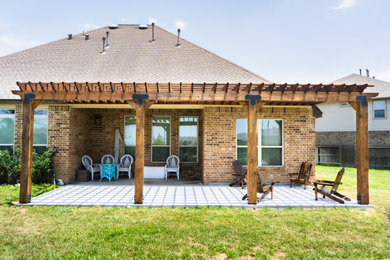Large arts and crafts backyard concrete patio photo in Houston with a bbq area and a pergola