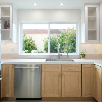 Modern White and Natural Oak Kitchen with Brass Hardware and Quartz Backsplash