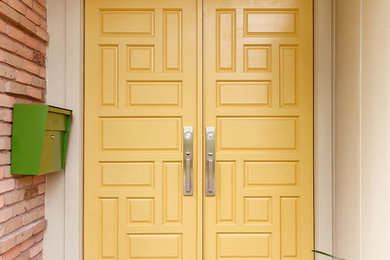 Entryway - large 1960s slate floor and gray floor entryway idea in Houston with beige walls and a yellow front door