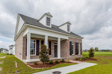 Example of a mid-sized classic one-story mixed siding gable roof design in New Orleans