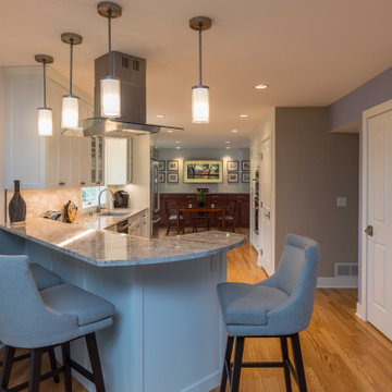Modern Kitchen with White Flat Panel Shaker Cabinets & Natural Stone Backsplash