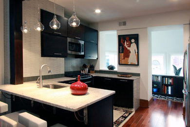 Mid-sized trendy u-shaped medium tone wood floor and brown floor open concept kitchen photo in DC Metro with a drop-in sink, flat-panel cabinets, dark wood cabinets, granite countertops, green backsplash, ceramic backsplash and stainless steel appliances