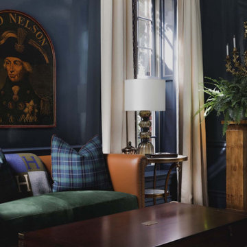 Seating area in a home bar lounge with dark navy blue high gloss lacquered walls