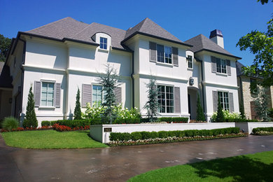 Trendy white house exterior photo in Other with a shingle roof