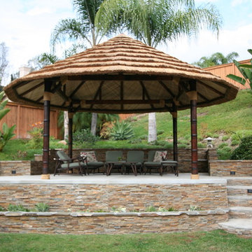 20' African reed hut with carved teak stained poles and sub-roof.