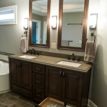 Dark Wood Vanity with Drawer Outlet and Double Mirrors and Wall Sconces
