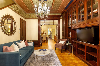 Mid-sized trendy formal and enclosed medium tone wood floor living room photo with beige walls, a standard fireplace and a stone fireplace