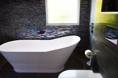 Photo of a large master bathroom in Glasgow with multi-coloured tile, mosaic tile and porcelain floors.