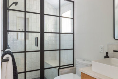 Small danish master white tile and porcelain tile porcelain tile, black floor and single-sink bathroom photo in New York with flat-panel cabinets, medium tone wood cabinets, a one-piece toilet, white walls, a vessel sink, quartz countertops, a hinged shower door, white countertops and a floating vanity