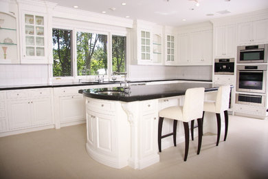 Large transitional u-shaped separate kitchen in Los Angeles with beaded inset cabinets, white cabinets, stainless steel appliances and with island.
