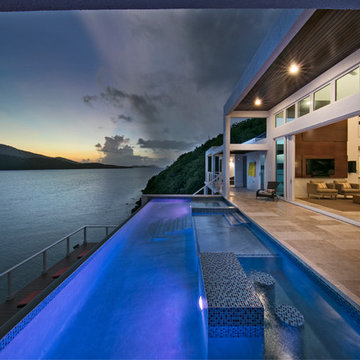 Night time view of an infinity pool with lighting in a contemporary St. Thomas v