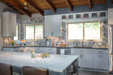 Example of a huge mid-century modern l-shaped dark wood floor open concept kitchen design in Portland with an undermount sink, flat-panel cabinets, gray cabinets, quartz countertops, multicolored backsplash, ceramic backsplash, stainless steel appliances and an island