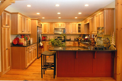 Mid-sized trendy u-shaped medium tone wood floor kitchen pantry photo in Charlotte with an undermount sink, raised-panel cabinets, medium tone wood cabinets, granite countertops, multicolored backsplash, ceramic backsplash, stainless steel appliances and no island