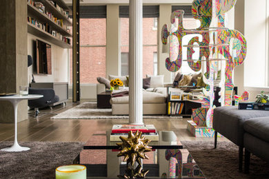 Example of a large trendy loft-style light wood floor and gray floor living room design in New York with gray walls