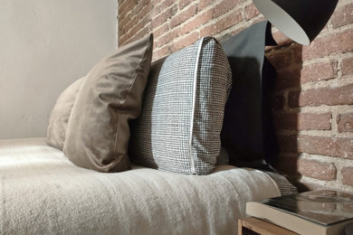 Inspiration for a small industrial master bedroom in Barcelona with brown walls, light hardwood flooring, brown floors, a wood ceiling and brick walls.