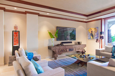 Living room - large tropical open concept travertine floor living room idea in Hawaii with beige walls, no fireplace and a wall-mounted tv