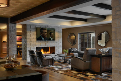 Transitional walk-out dark wood floor, exposed beam and wallpaper basement photo in St Louis with a home theater and a stone fireplace