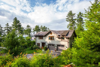 Small arts and crafts green two-story wood exterior home photo in Portland Maine with a shingle roof