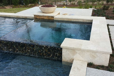Design ideas for a mid-sized transitional backyard rectangular pool in Houston with stamped concrete.
