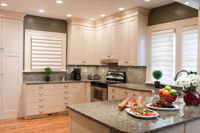 Eat-in kitchen - mid-sized transitional u-shaped light wood floor eat-in kitchen idea in Cedar Rapids with a double-bowl sink, shaker cabinets, white cabinets, granite countertops, gray backsplash, stainless steel appliances and an island
