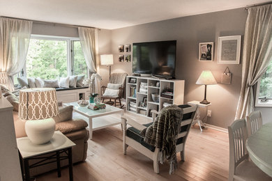 Transitional open concept light wood floor living room photo in Toronto with beige walls, no fireplace and a tv stand