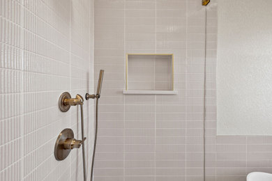 Mid-sized french country master white tile and porcelain tile porcelain tile, white floor, double-sink, vaulted ceiling and wainscoting bathroom photo in Austin with shaker cabinets, light wood cabinets, a one-piece toilet, white walls, an undermount sink, quartz countertops, a hinged shower door, white countertops, a niche and a built-in vanity