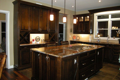 Inspiration for a large transitional l-shaped ceramic tile open concept kitchen remodel in Toronto with raised-panel cabinets, dark wood cabinets, granite countertops, an island, a double-bowl sink and stainless steel appliances