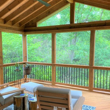 Wood screened-in porch featuring a ceiling fan