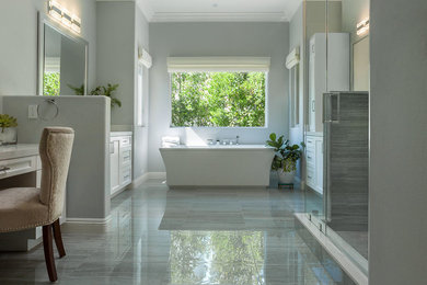 Inspiration for a large modern master gray tile and porcelain tile porcelain tile and gray floor bathroom remodel in Los Angeles with shaker cabinets, white cabinets, a two-piece toilet, blue walls, an undermount sink, quartz countertops and a hinged shower door