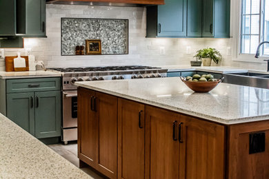 Eat-in kitchen - huge transitional u-shaped vinyl floor and beige floor eat-in kitchen idea in DC Metro with a farmhouse sink, shaker cabinets, green cabinets, recycled glass countertops, an island and beige countertops