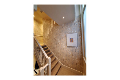 Medium sized contemporary l-shaped staircase in London with wallpapered walls and a feature wall.