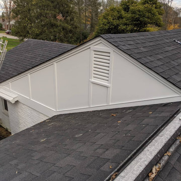 Board and Batton siding on an older brick home