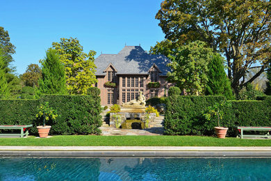 Traditional red three-story brick exterior home idea in New York with a hip roof