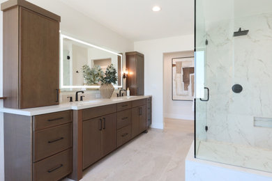 Bathroom - large transitional master white tile and porcelain tile porcelain tile, beige floor and double-sink bathroom idea in Phoenix with shaker cabinets, dark wood cabinets, white walls, an undermount sink, quartz countertops, a hinged shower door and white countertops
