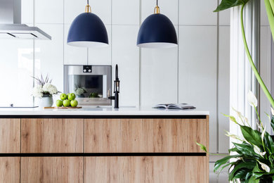 Example of a small trendy porcelain tile and white floor kitchen design in Other with an undermount sink, glass-front cabinets, white cabinets, quartzite countertops, stainless steel appliances, an island and white countertops