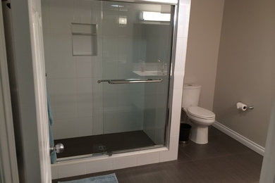 Mid-sized transitional white tile alcove shower photo in Calgary with flat-panel cabinets, white cabinets, beige walls and an integrated sink