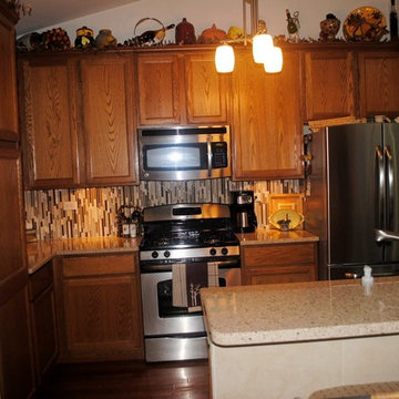 Updated quartz countertops and modern glass tile backsplashes