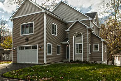Inspiration for a large transitional beige two-story vinyl gable roof remodel in Baltimore