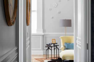 Inspiration for a mid-sized eclectic light wood floor, beige floor, vaulted ceiling and wainscoting hallway remodel in Chicago with gray walls