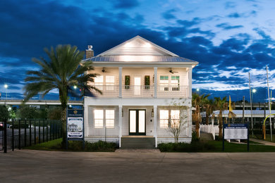Mid-sized beach style white two-story concrete fiberboard exterior home photo in Jacksonville with a clipped gable roof