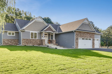 Example of an arts and crafts gray mixed siding exterior home design in Minneapolis