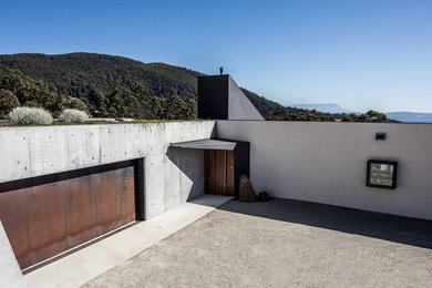 Photo of a contemporary one-storey concrete exterior in Hobart with a flat roof.