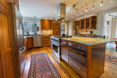 Large eclectic l-shaped medium tone wood floor eat-in kitchen photo in Burlington with a single-bowl sink, recessed-panel cabinets, medium tone wood cabinets, granite countertops, multicolored backsplash, ceramic backsplash and an island