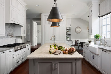 Photo of a transitional kitchen in Orange County with a farmhouse sink, raised-panel cabinets, white cabinets, multi-coloured splashback, stainless steel appliances, medium hardwood floors and with island.